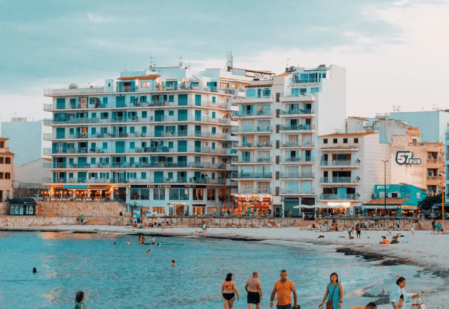 Playa urbana con bañistas y edificios frente al mar.